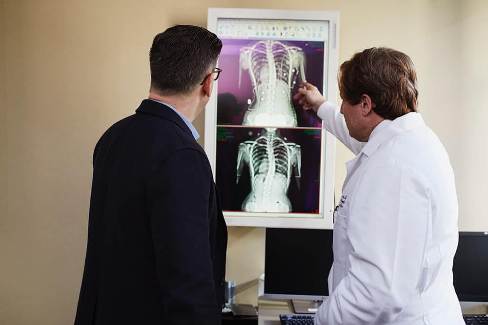 Doctor explaining x ray to man