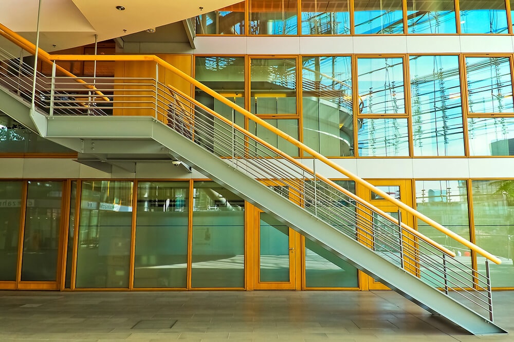 Stairs in front of glass panel wall