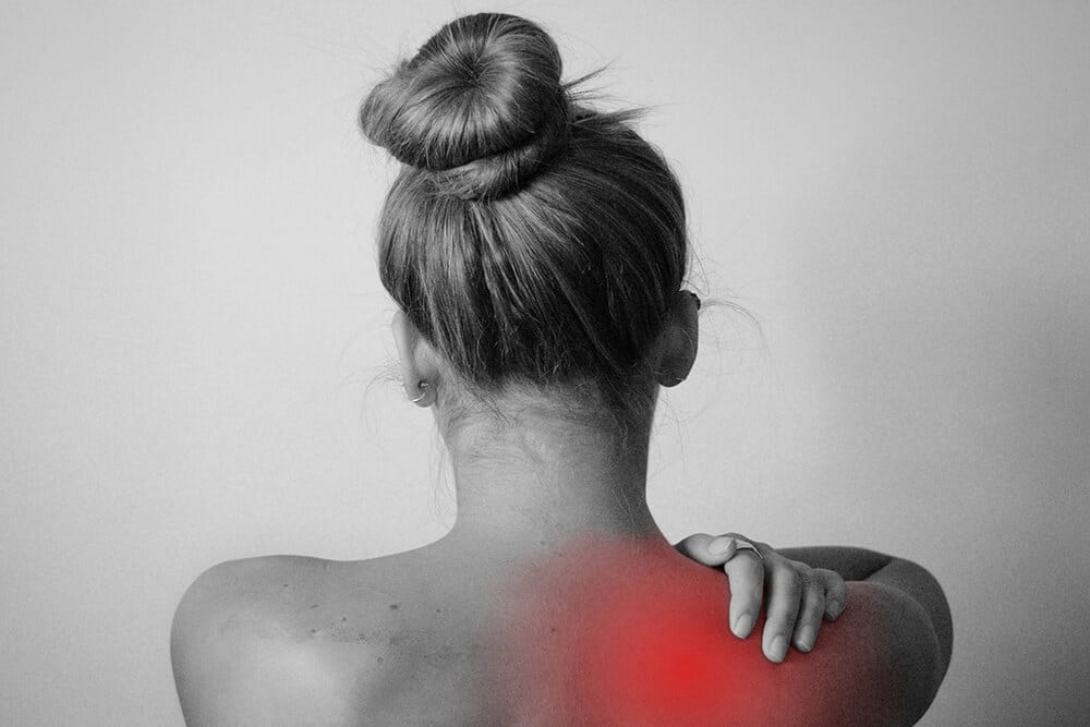 Woman with hurt shoulder